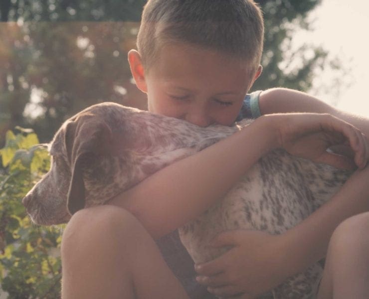 A boy with his hunting dog.