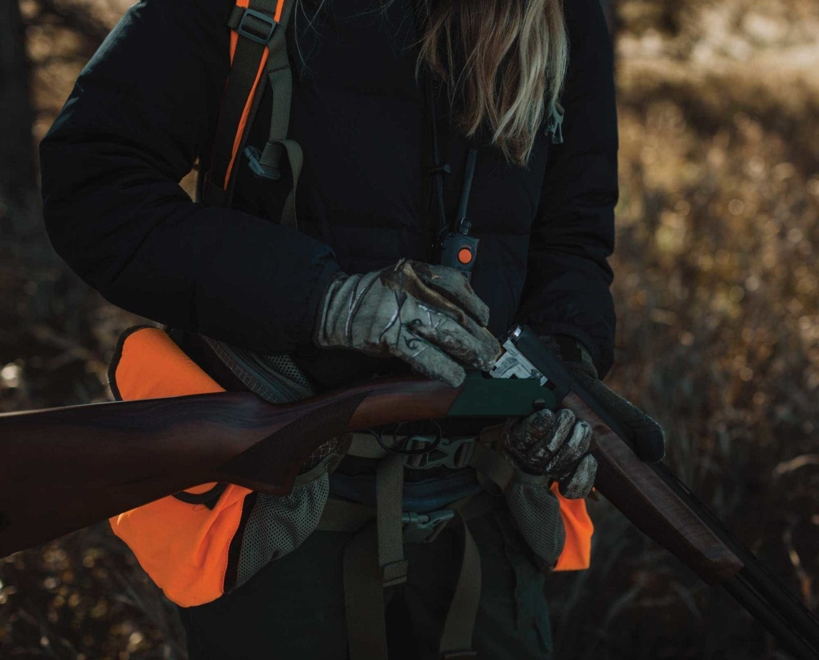 A pheasant hunter loads theor shotgun with ammunition