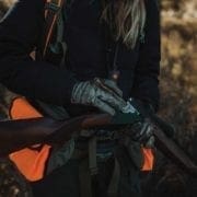 A pheasant hunter loads theor shotgun with ammunition