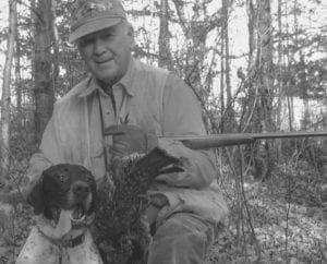 bird hunter with German short-haired pointer and ruffed grouse.