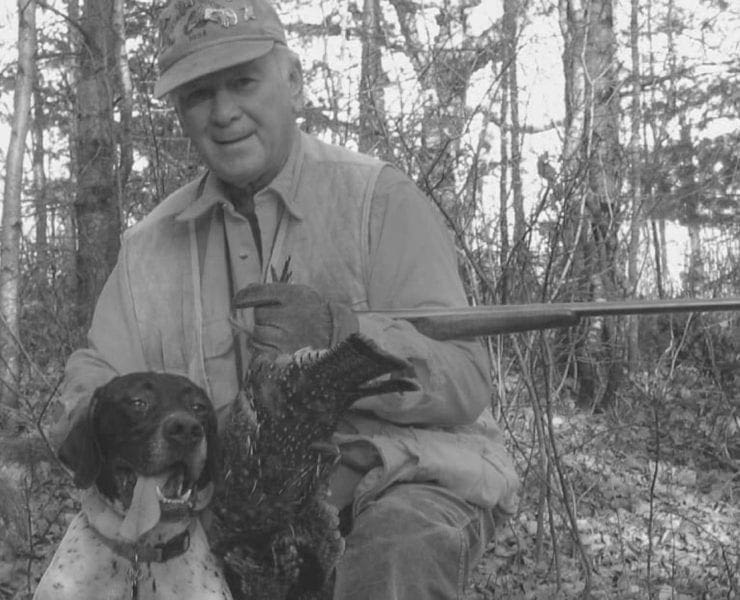 bird hunter with German short-haired pointer and ruffed grouse.
