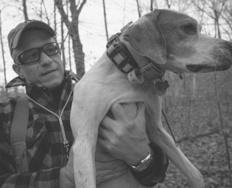 Gregg Elliot holding his bird hunting dog
