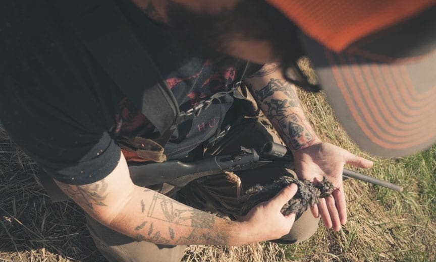 A hunter holds a California quail