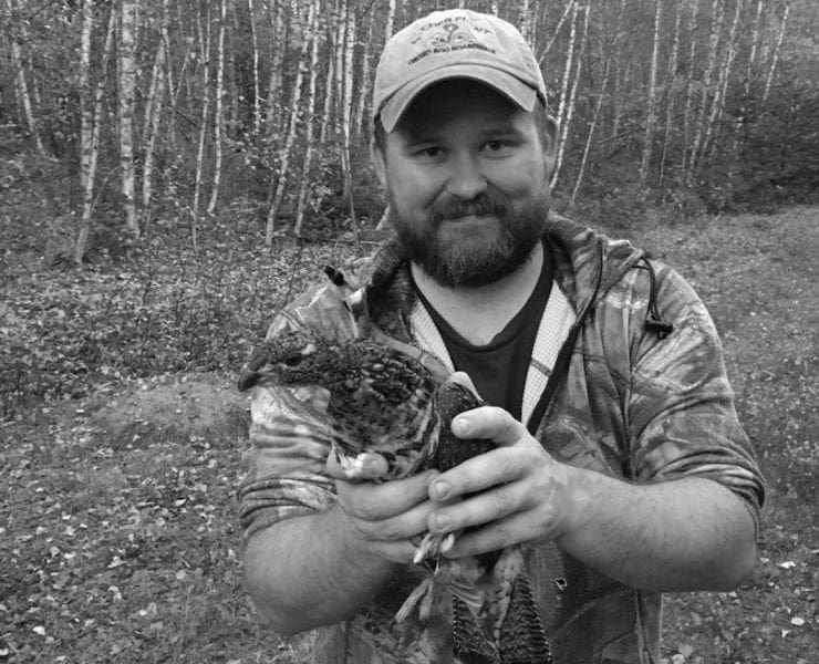 Erik Blomberg with a live trap ruffed grouse