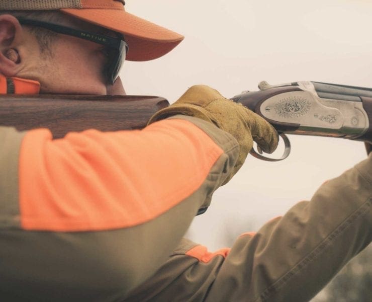 A bird hunter practices gun mount with his shotgun.