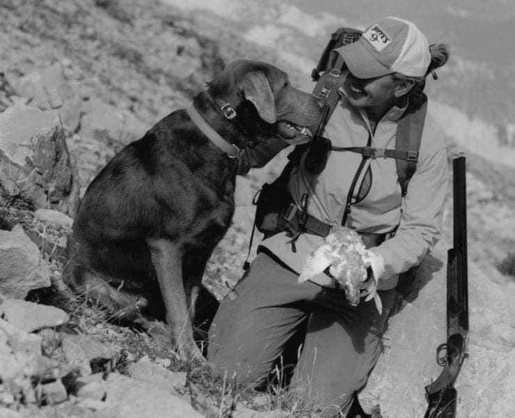 Gun Dog Magazine Editor in Chief Kali Parmley hunting Ptarmigan with her Labrador retriever.