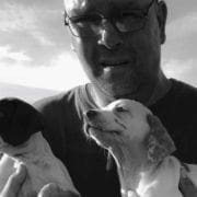 Bird dog trainer Dave Jones holding two puppies.