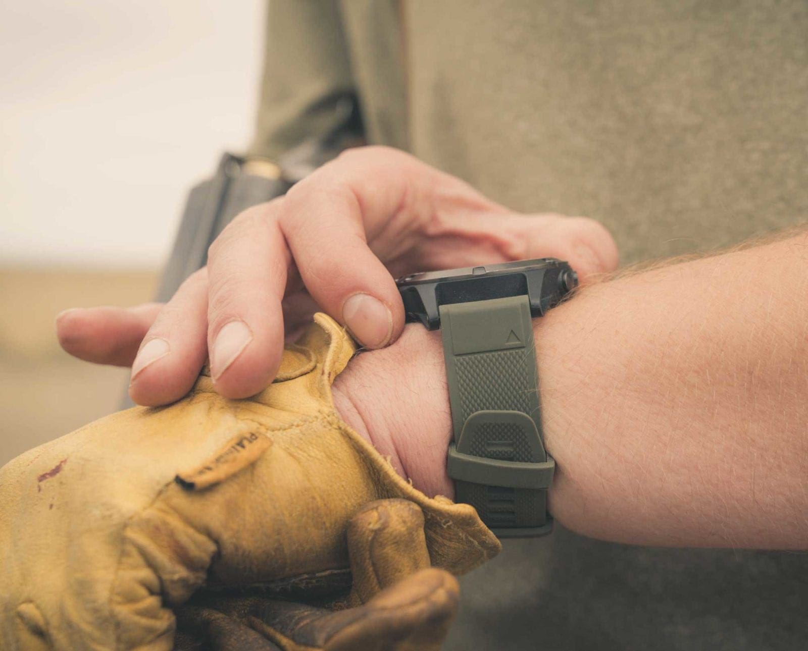 A bird hunter uses his Garmin Fenix 5 GPS watch with a Garmin Alpha.