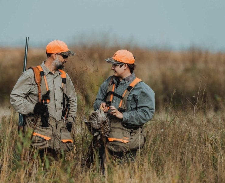 two bird hunters with prairie chickens