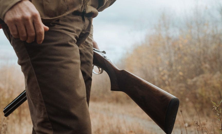Dr Ben Jones hols a shotgun while grouse hunting. 