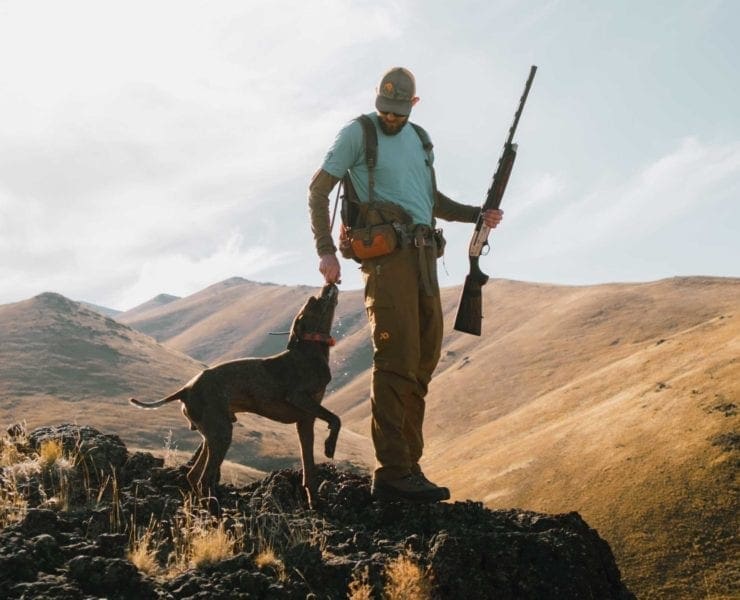 A chukar hunter and his dog overlooking chukar country