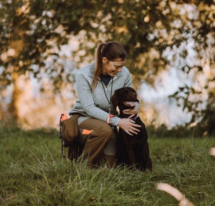A bird hunter with her hunting dog
