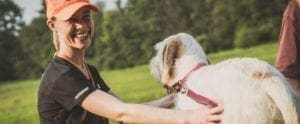 a women handles a bird dog