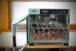 Strips of pheasant jerky in a food dehydrator