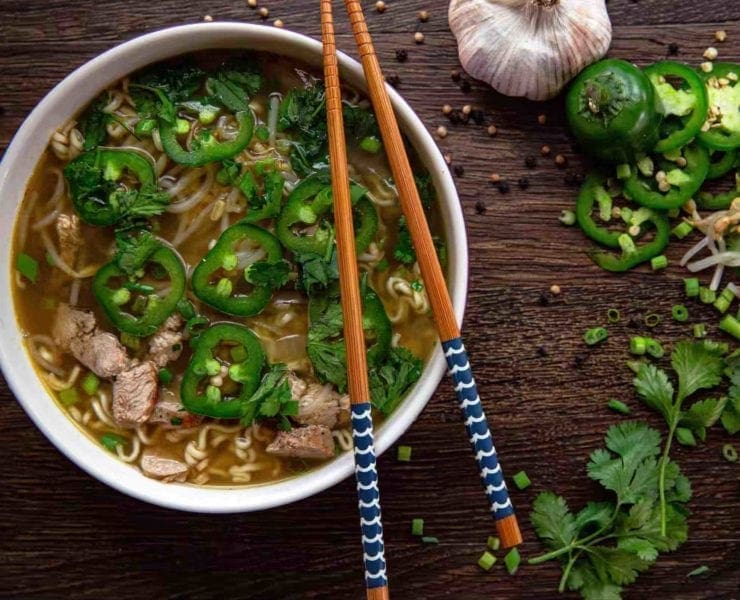 a bowl of pheasant pho with chopsticks.