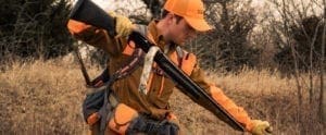 A bird hunter uses a bore snake to clean his shotgun