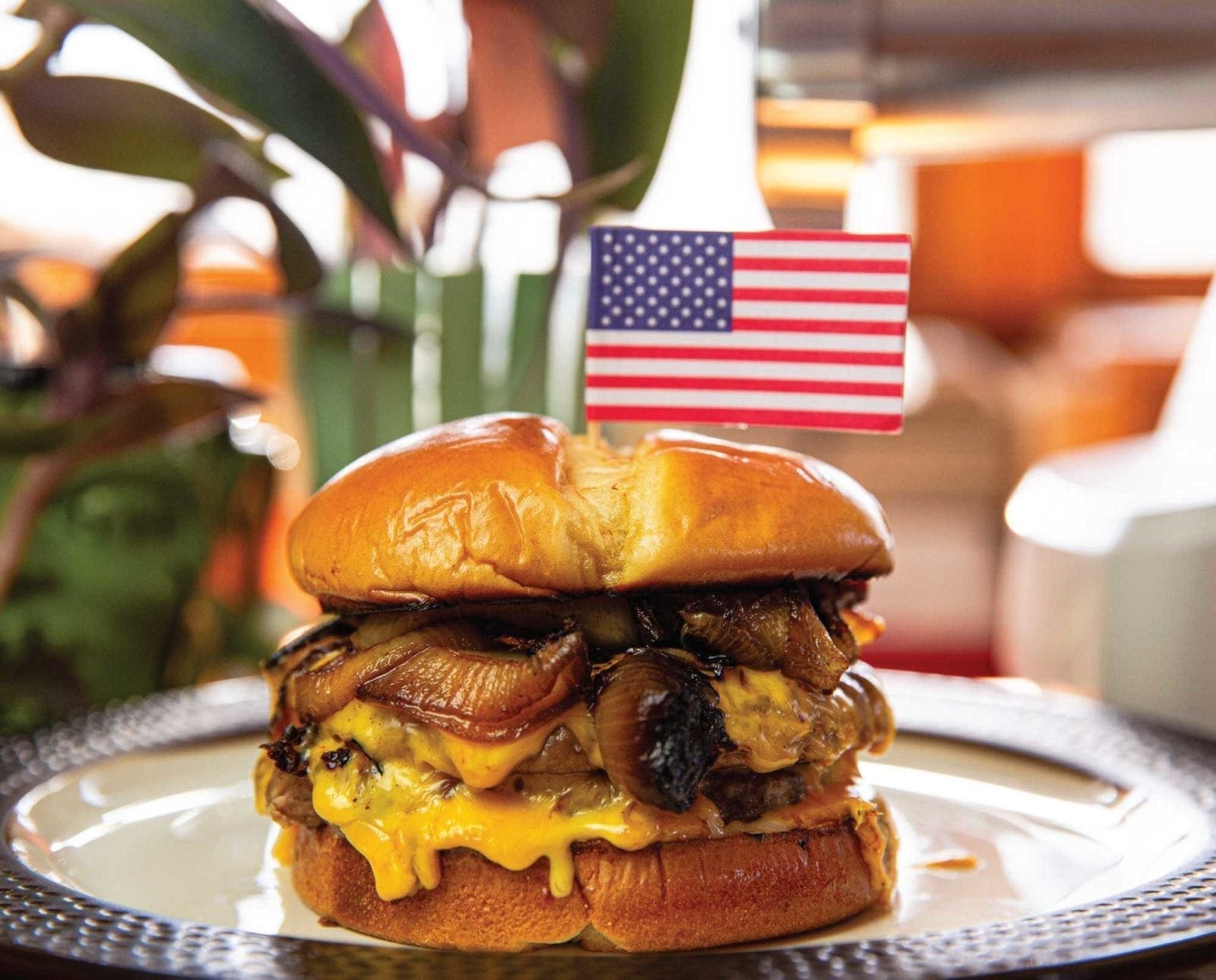 An upland burger sits on a table ready to eat.