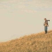 A bird hunter looks for prairie chickens in Kansas