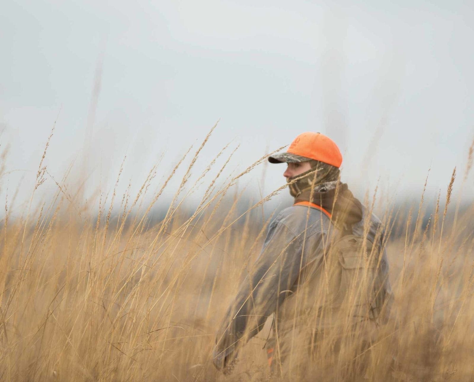 A Pheasant hunter walks alone in a field