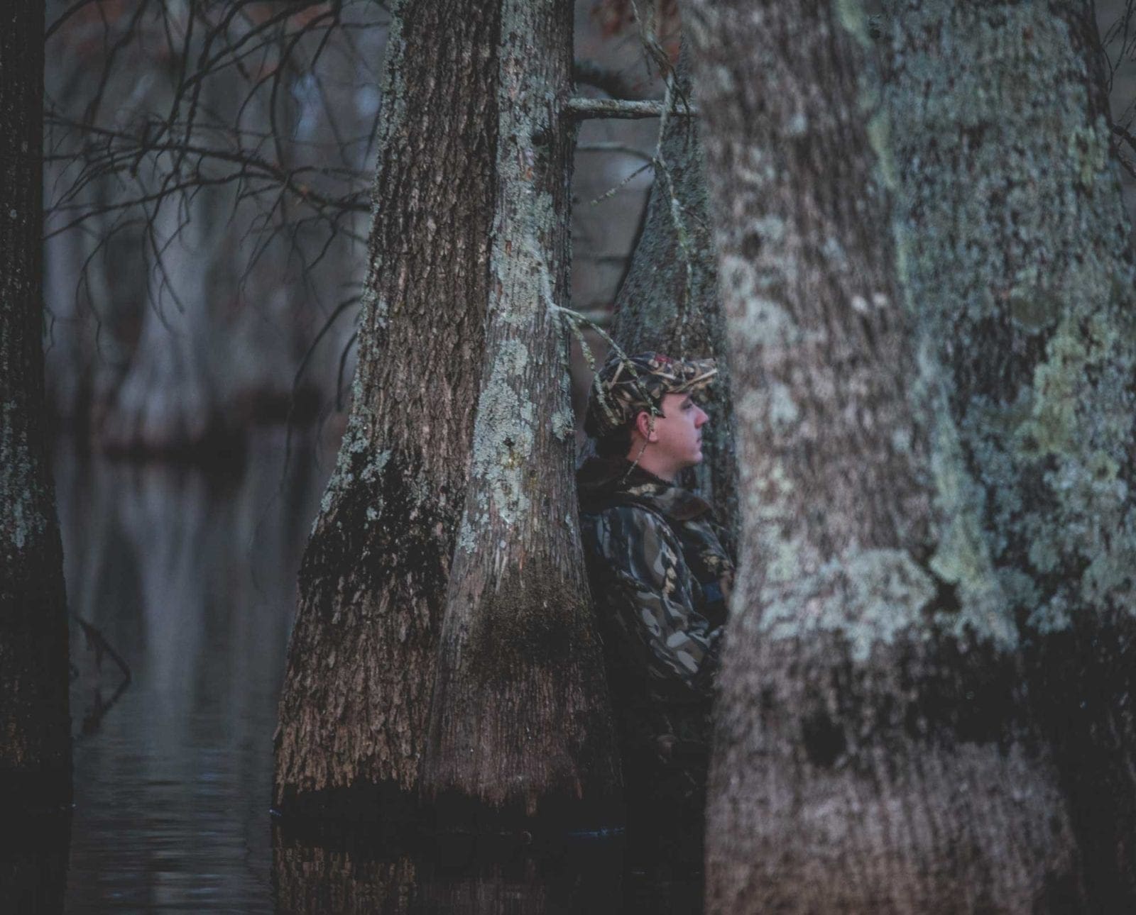 A young duck hunter set up in a swamp