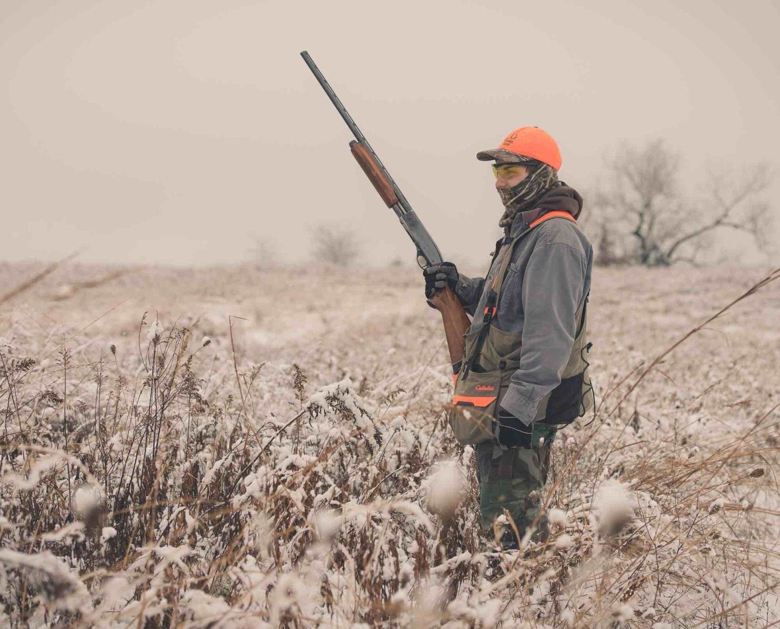 A pheasant hunter in a snowy field