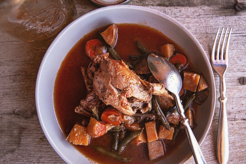 Canned quail in a bowl with vegetable stew