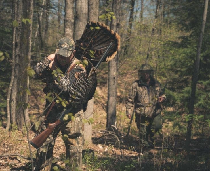 Turkey hunters in the spring woods after shooting a turkey