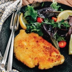 grouse milanese on a plate with salad.