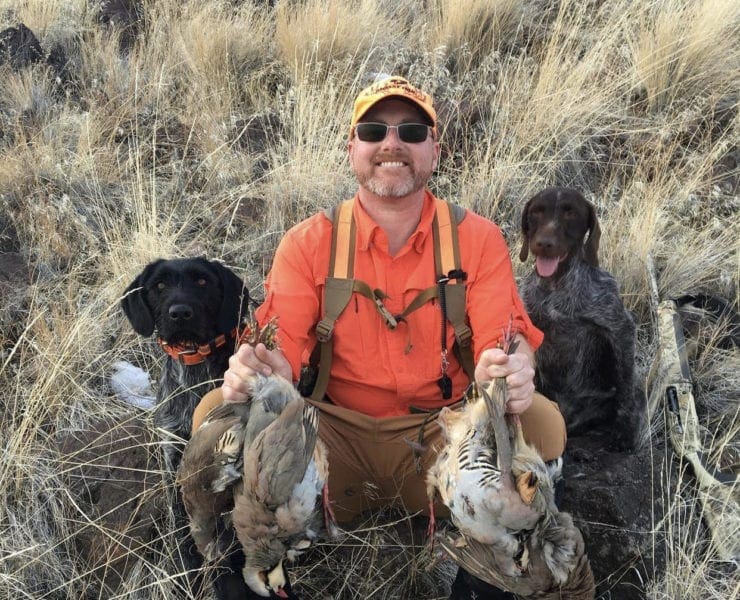 Biologist Dominic Bachman hunting chukar with his dogs