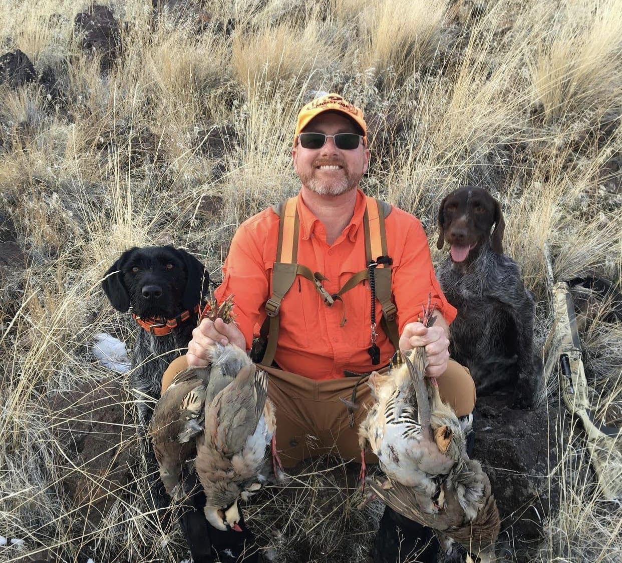 Biologist Dominic Bachman hunting chukar with his dogs