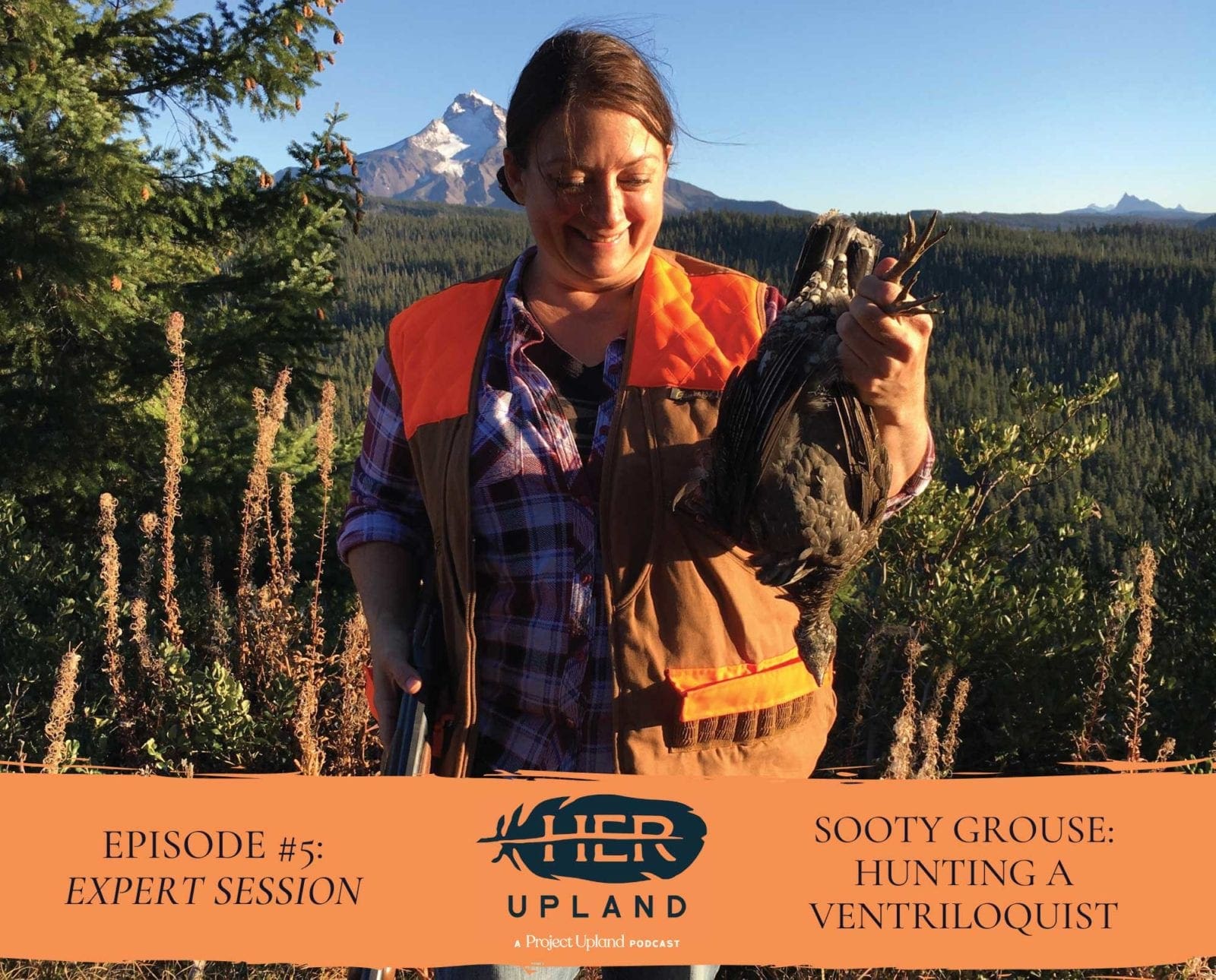 A woman hunter holds a sooty grouse