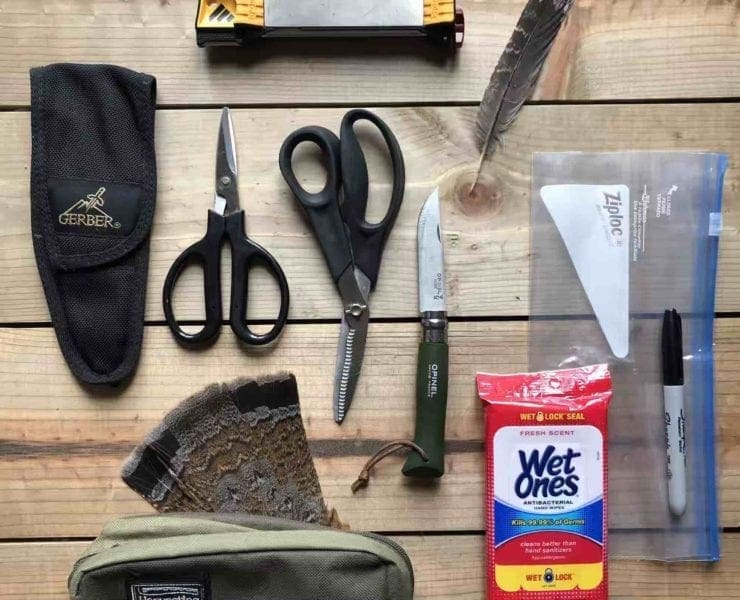 Supplies for a bird cleaning kit including knife and shears