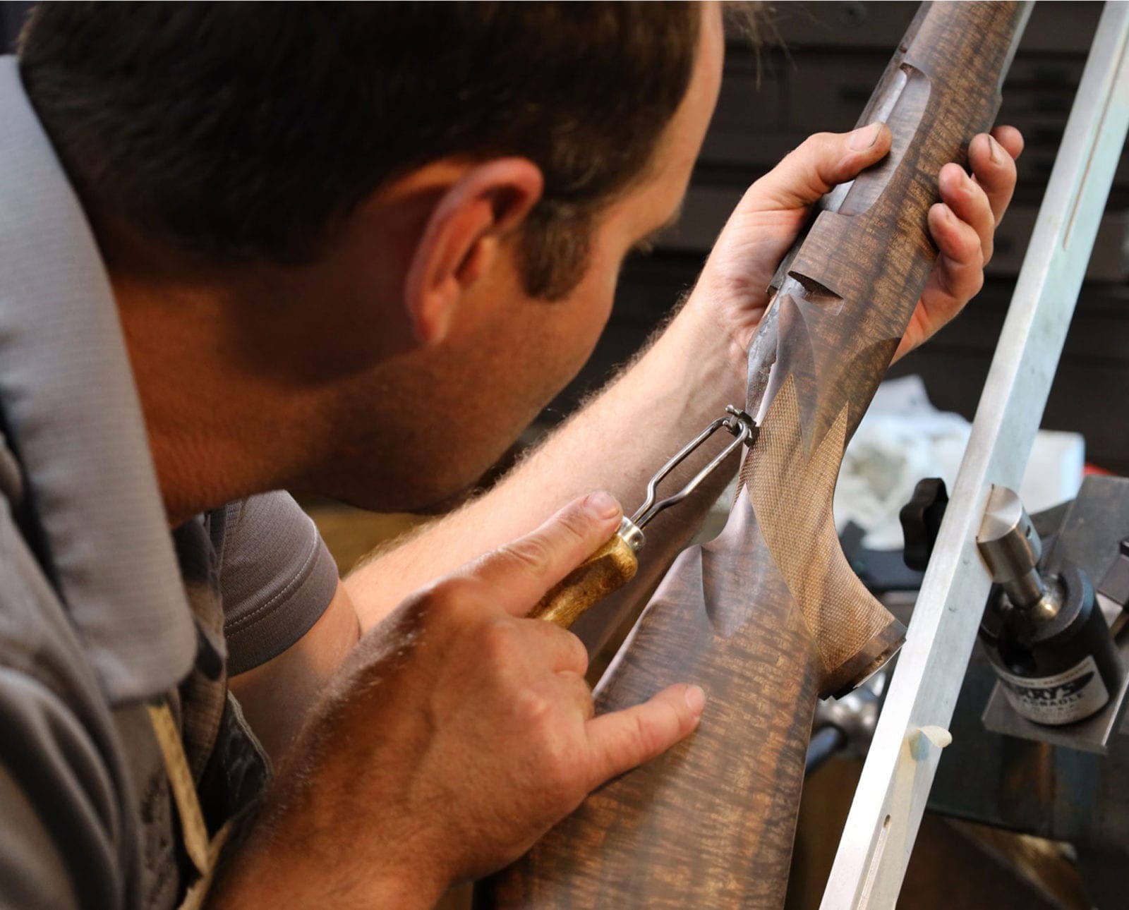 A Griffin and Howe gunsmith works on a rifle.