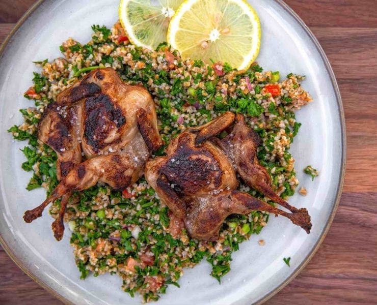 Grilled quail served atop a fresh tabbouleh salad
