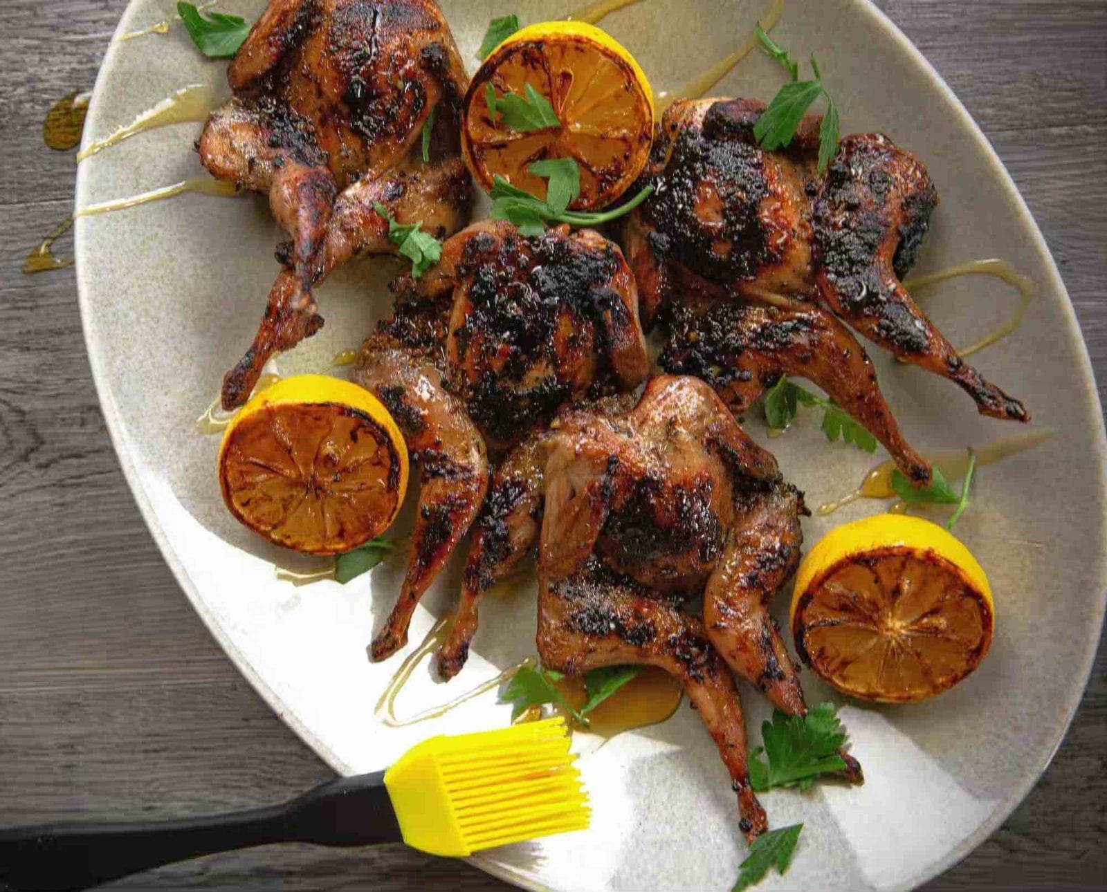 Grilled lemon and honey quail on a platter