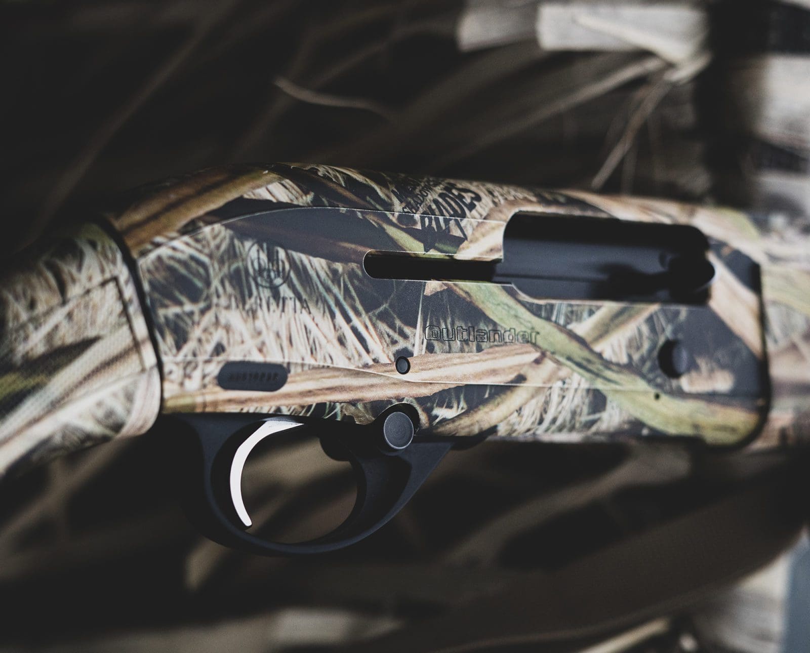 A Beretta A300 Outlander rests on a duck blind.