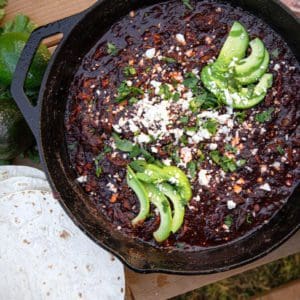 Mexican mole rests in a cast iron skillet.