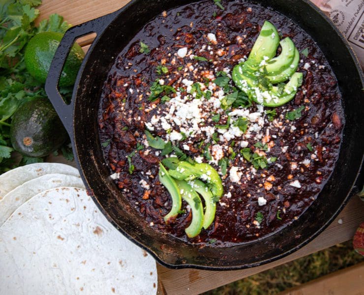 Mexican mole rests in a cast iron skillet.