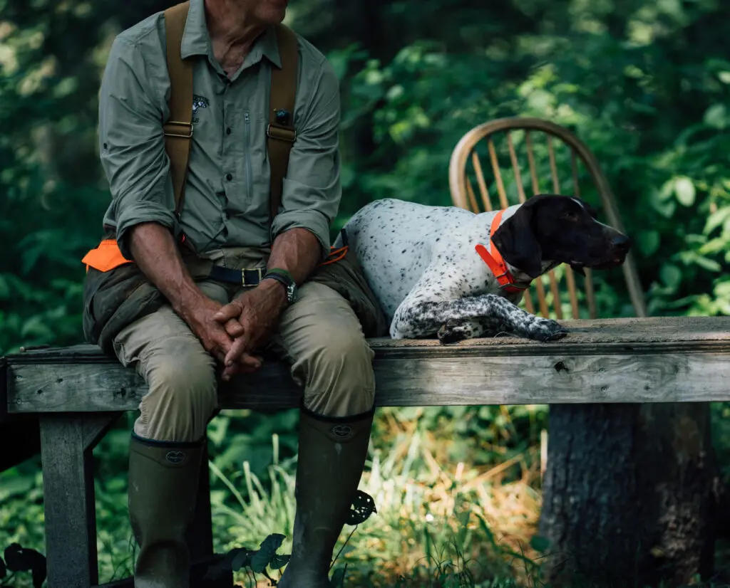 A dog trainer with a German Shorthaired Pointer