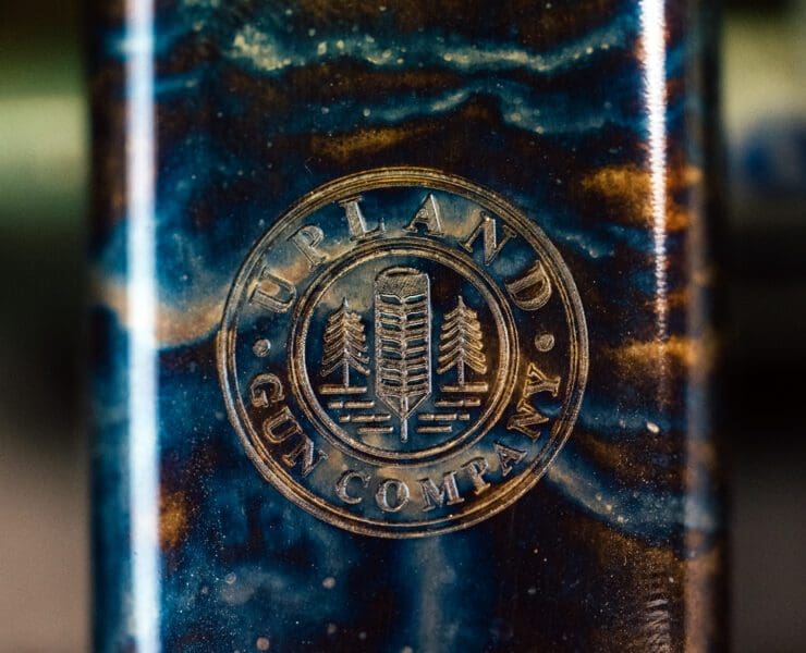 The view of the bottom of a shotgun receiver with the Upland Gun Company logo.