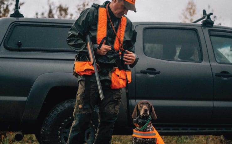 Dog trainer Jason Carter commands his dog in the field