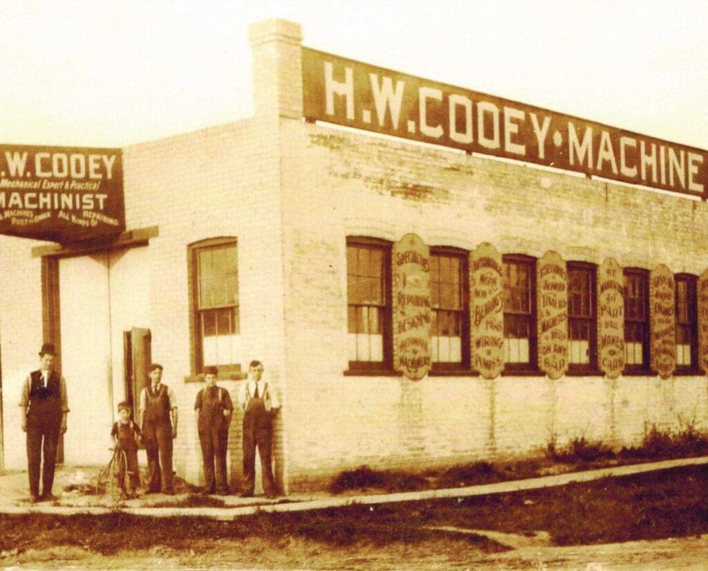workers stand outside the Cooey machine shop