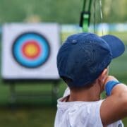 An elementary student learning archery safety for hunter education