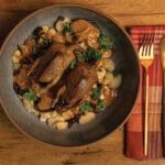 Roasted Dove with Butter Beans and Brandy-Vermouth Cream Sauce on a dinner plate