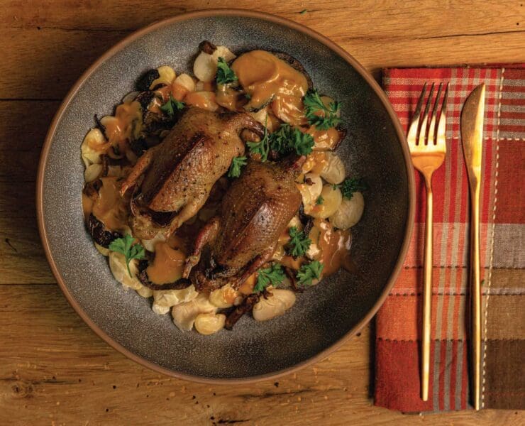 Roasted Dove with Butter Beans and Brandy-Vermouth Cream Sauce on a dinner plate