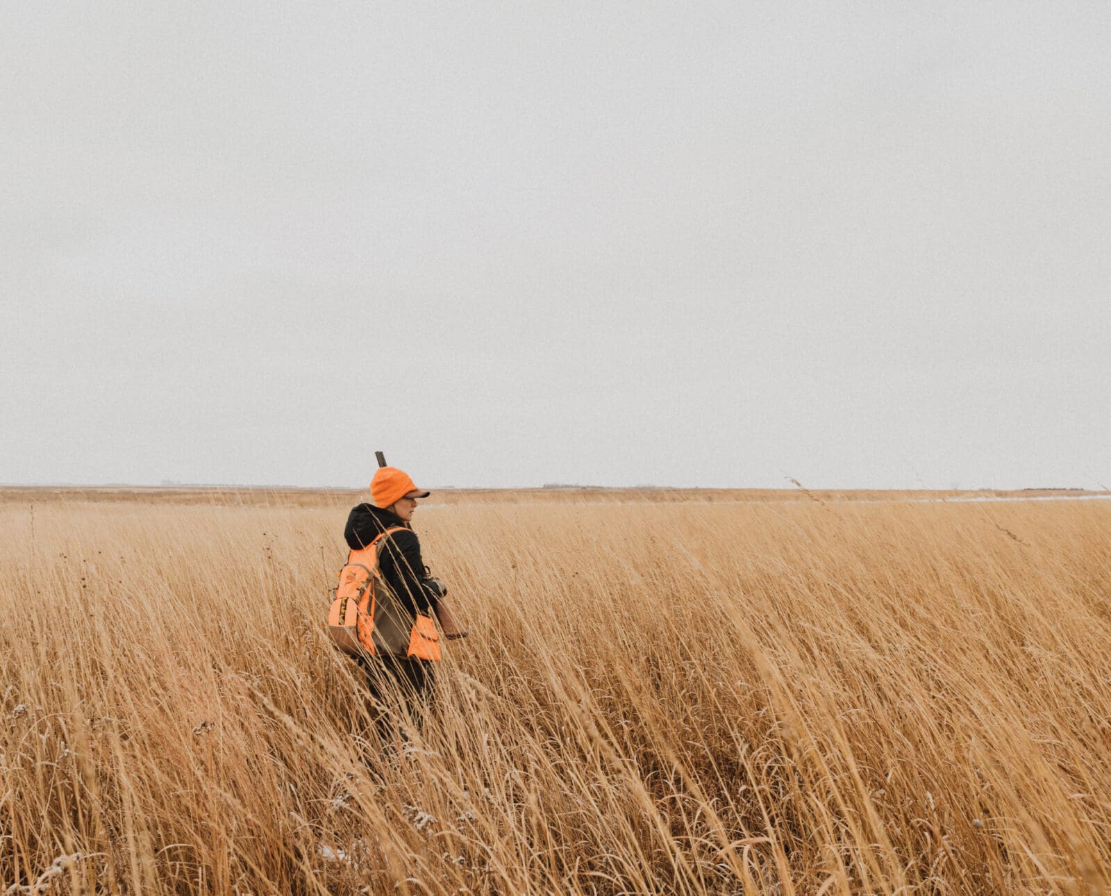A Bird hunter walks grasslands in Nebraska.