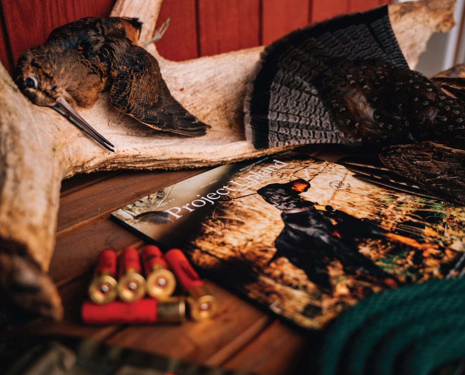 An issue of project upland magazine with some upland hunting gear and grouse