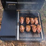 Quail placed on a pellet smoking grill
