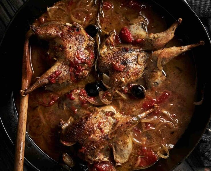 Hungarian partridges cooking in a tomato broth for cacciatore dish