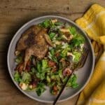 Roasted whole quail on a bed of lettuce for a Mediterranean inspired fattoush salad